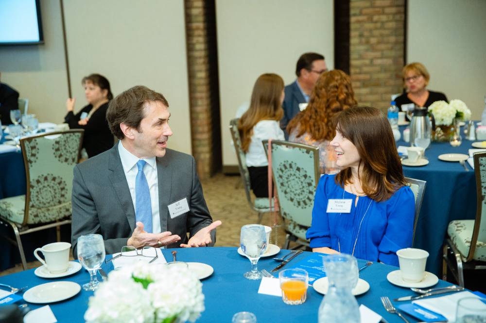 Two guests talking with each other at Scholarship Dinner 2019
